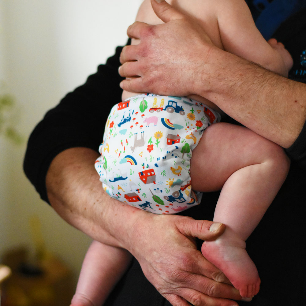 A Tots Bots Easyprint nappy featuring the life at a farm print.